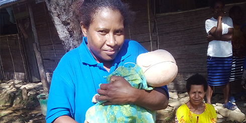 VBA volunteer displaying a dummy baby at the training